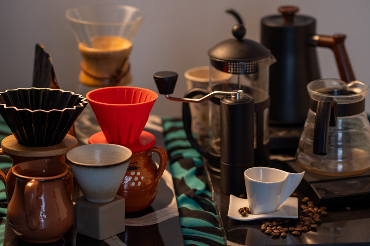 Explore an array of coffee brewing tools including drippers, grinders, and cups, ideal for crafting specialty coffee at home.